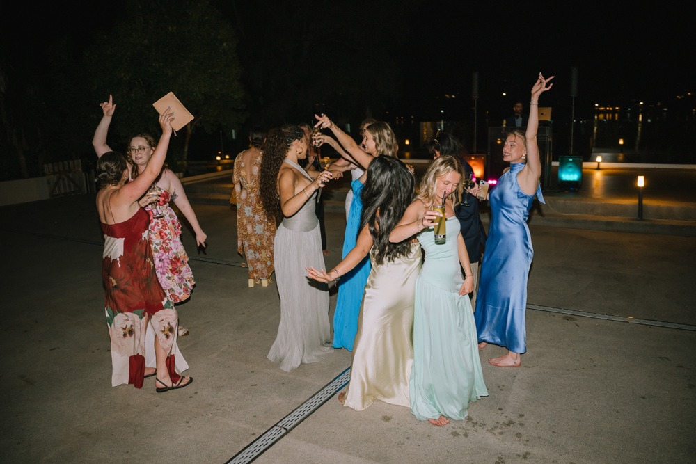 candid shot of guests dancing barefoot after reception