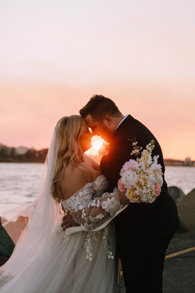 timeless portrait of couple embracing during golden hour sunset session after wedding
